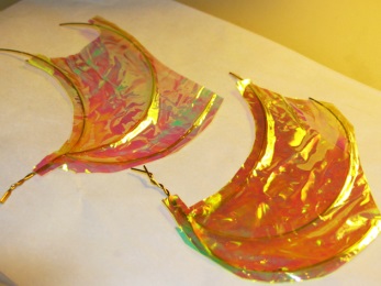 trim transparent film around fairy wing edges.